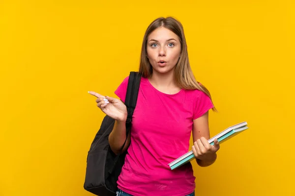 Young Student Girl Isolated Yellow Background Surprised Pointing Side — Stock Photo, Image