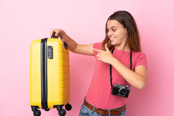 Teenager Traveler Girl Holding Suitcase Isolated Pink Background Pointing — 图库照片