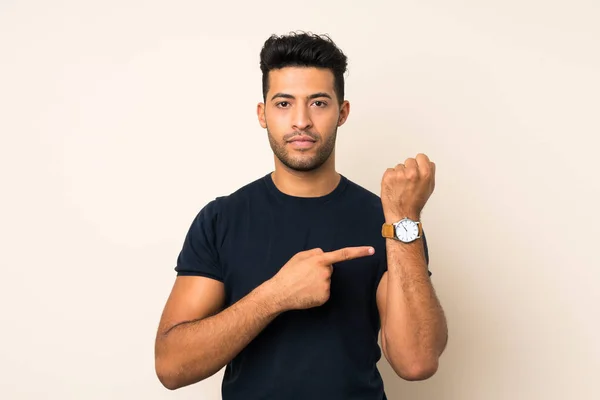 Joven Hombre Guapo Sobre Fondo Aislado Que Muestra Reloj Mano — Foto de Stock