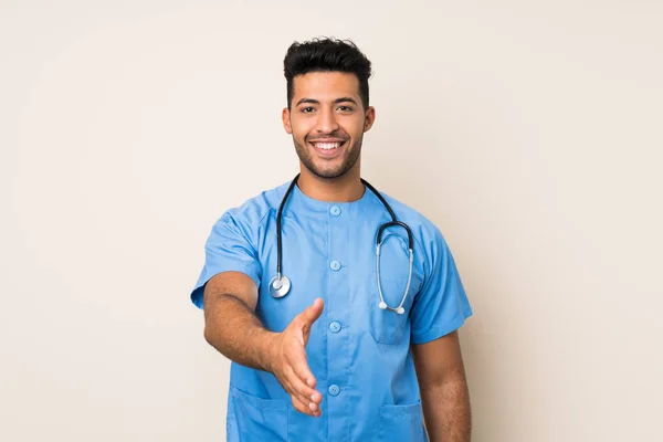 Joven Hombre Guapo Sobre Fondo Aislado Con Bata Médico Hacer —  Fotos de Stock