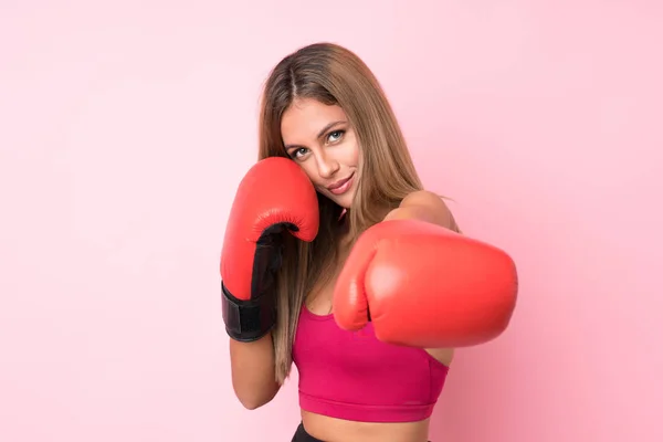 Young sport blonde woman with boxing gloves over isolated pink background — Stock Photo, Image