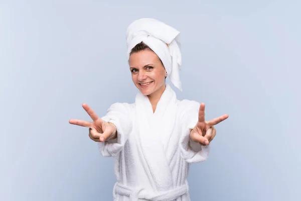 Woman Bathrobe Isolated Blue Background Smiling Showing Victory Sign — 스톡 사진