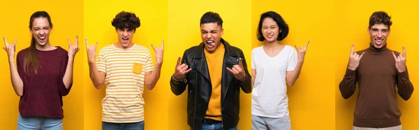 Set of people over isolated yellow background making rock gesture