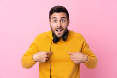 Kulaklığı olan genç yakışıklı bir adam. Soyutlanmış pembe bir geçmişi var.