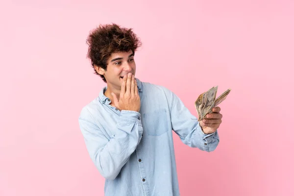 Joven Caucásico Hombre Sobre Aislado Rosa Fondo Tomando Montón Dinero — Foto de Stock