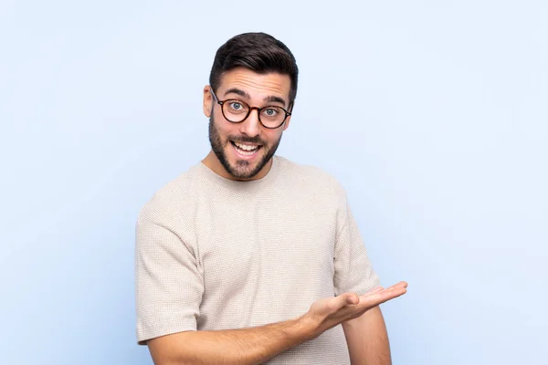 Jovem Homem Bonito Com Barba Sobre Fundo Azul Isolado Estendendo — Fotografia de Stock