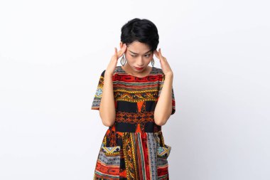 Young Asian girl with a colorful dress over isolated white background with headache