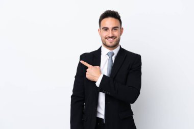 Young business man over isolated background pointing finger to the side