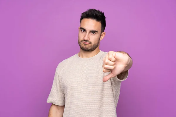 Young Handsome Man Isolated Purple Background Showing Thumb Negative Expression — 스톡 사진