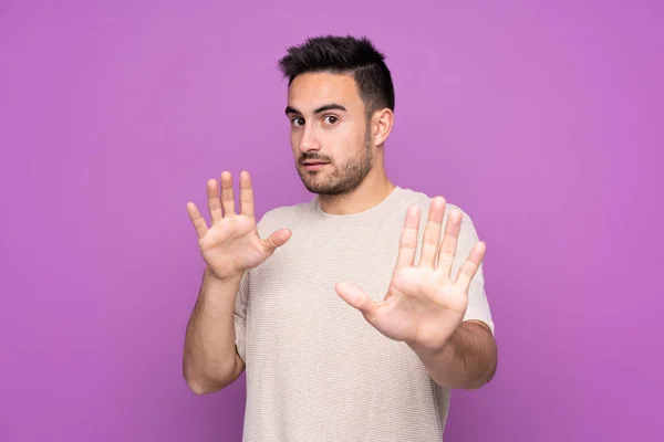 Young Handsome Man Isolated Purple Background Nervous Stretching Hands Front — 스톡 사진