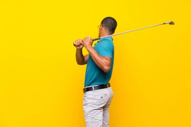 Izole sarı arka plan üzerinde Afro Amerikan golfçü oyuncu adam
