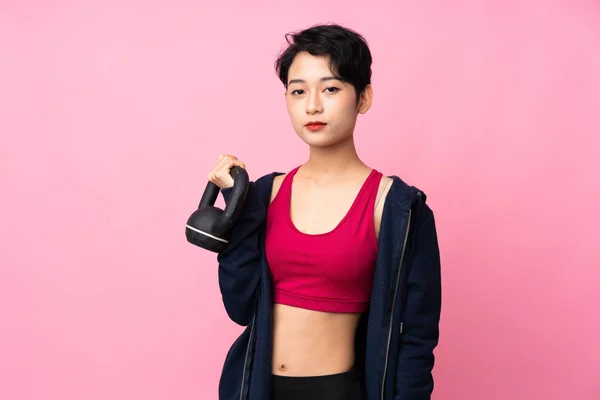 Young Sport Asian Woman Isolated Pink Background Making Weightlifting Kettlebell — 스톡 사진