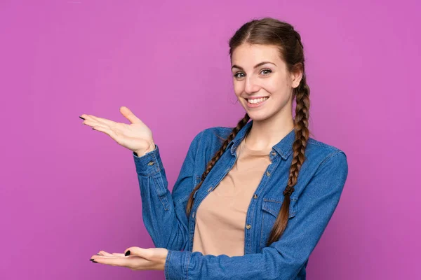 Jonge Vrouw Geïsoleerde Paarse Achtergrond Reikende Handen Aan Zijkant Voor — Stockfoto