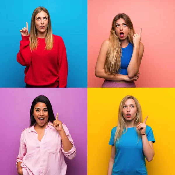 Set of women over isolated backgrounds thinking an idea pointing the finger up