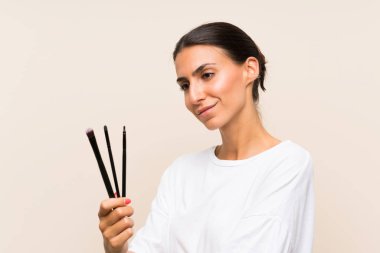 Makyaj fırçası tutan genç kadın