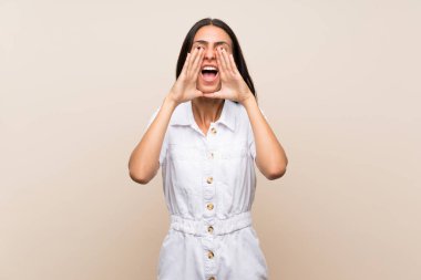 Izole arka plan üzerinde genç kadın bağırarak ve bir şey ilan