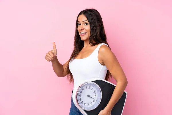 Young Woman Isolated Pink Background Holding Weighing Machine Thumb — 스톡 사진