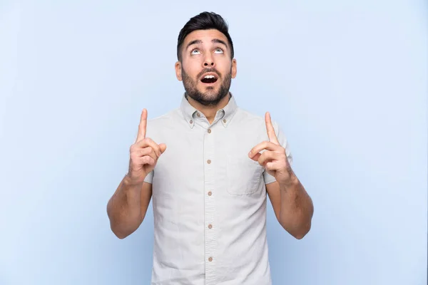 Young Handsome Man Beard Isolated Blue Background Pointing Index Finger — Stock Photo, Image