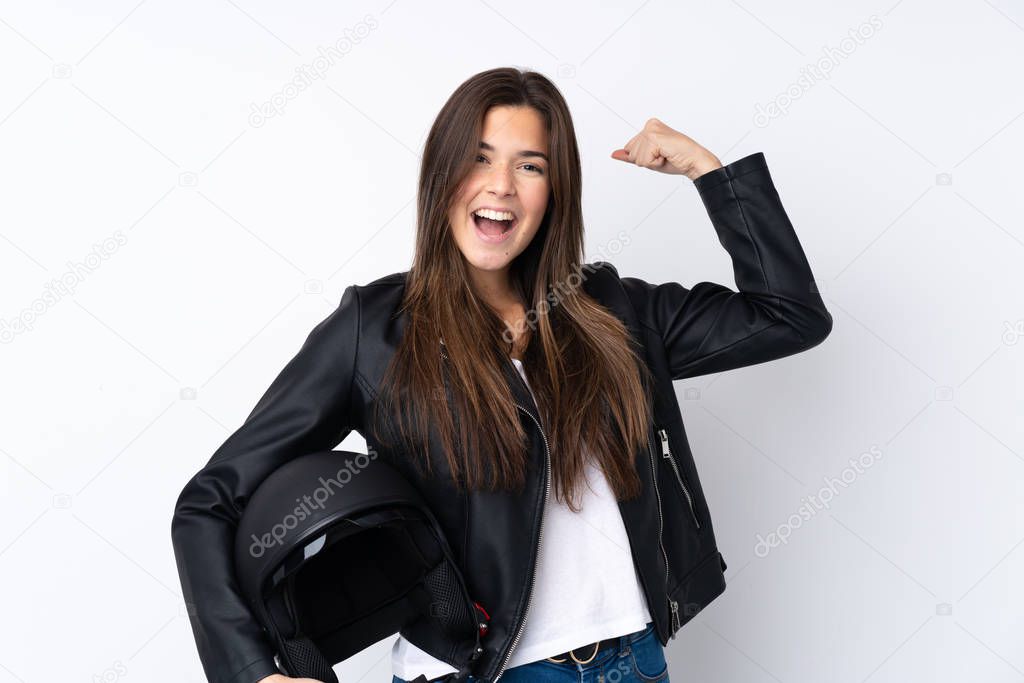 Young woman with a motorcycle helmet over isolated white background celebrating a victory