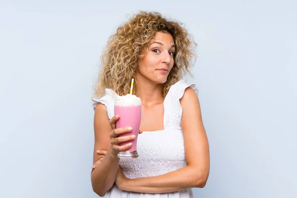 Young Blonde Woman Curly Hair Holding Strawberry Milkshake Making Doubts — 스톡 사진