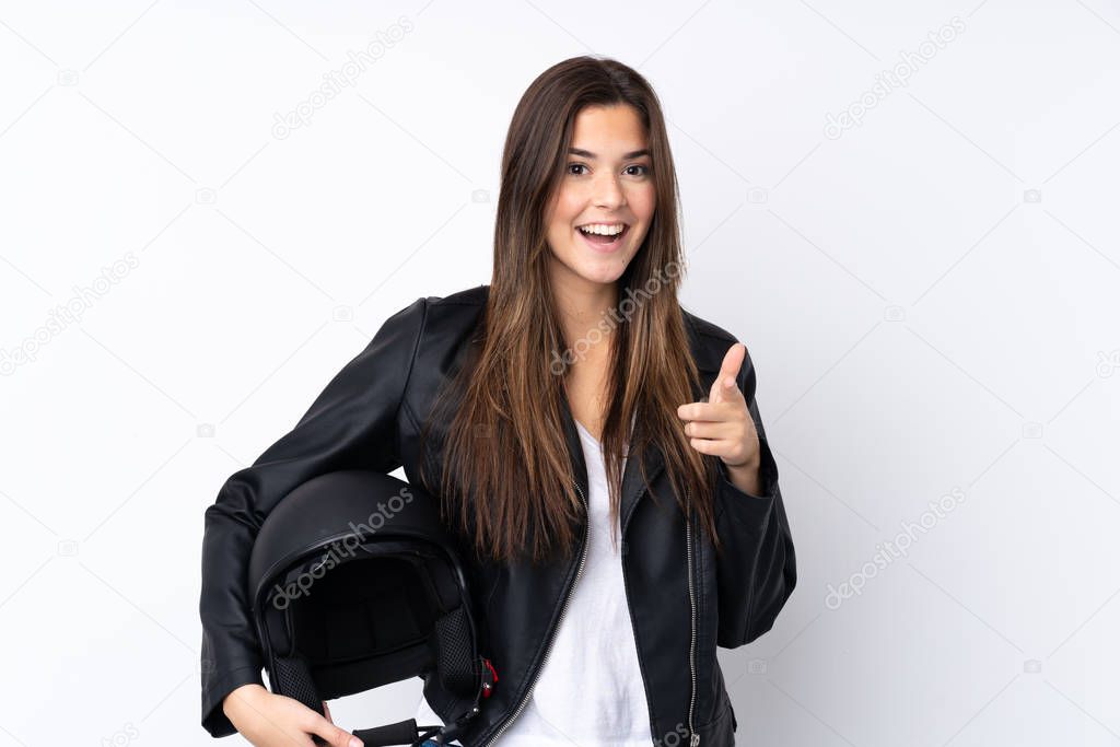 Young woman with a motorcycle helmet over isolated white background points finger at you