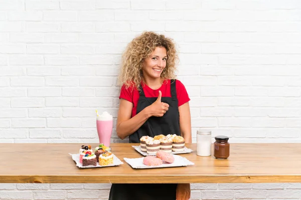 Mujer Joven Con Montón Diferentes Mini Pasteles Una Mesa Dando — Foto de Stock
