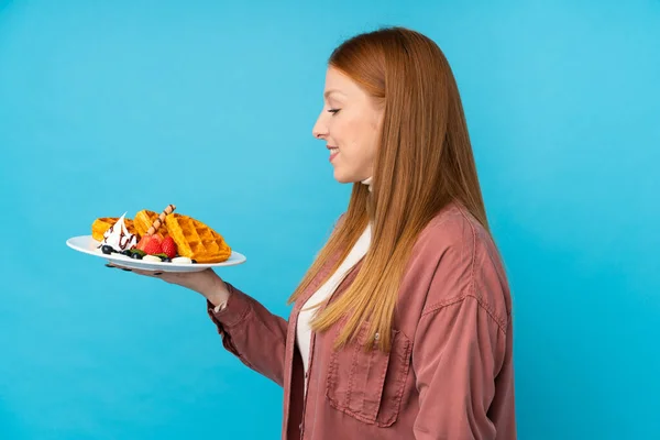 Young Redhead Woman Holding Waffles Isolated Background Happy Expression — Stock Photo, Image