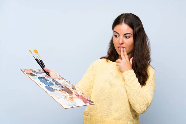 Ung Konstnär Kvinna Över Isolerad Blå Bakgrund Med Överraskning Och — Stockfoto