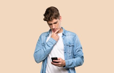 Yakışıklı genç adam düşünüp izole bir geçmiş üzerinden mesaj gönderiyor.