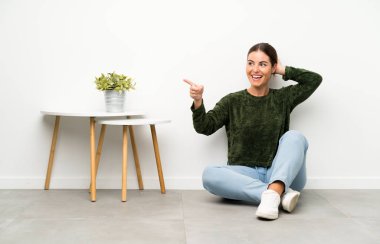 Yan kat şaşırmış ve işaret parmak üzerinde oturan genç kadın