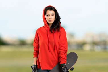 Kırmızı sweatshirt ile genç patenci kadın