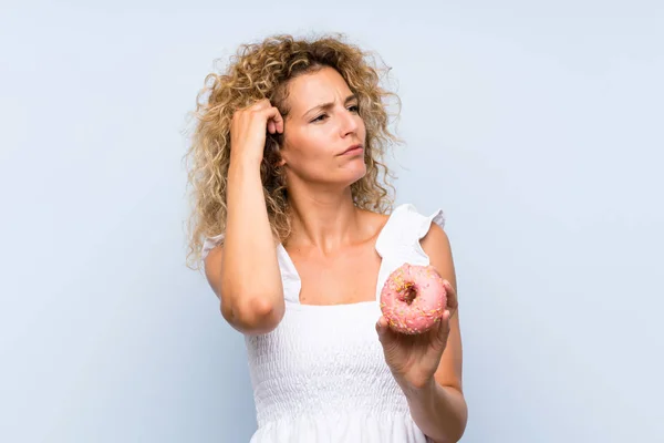 Young Blonde Woman Curly Hair Holding Donut Isolated Blue Background — 스톡 사진