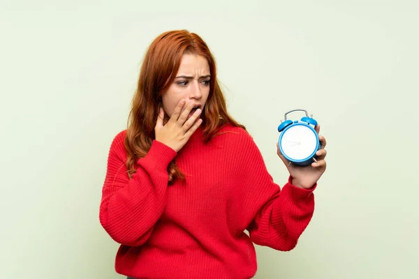 Teenager Redhead Girl Sweater Isolated Green Background Holding Vintage Alarm — Stock Photo, Image