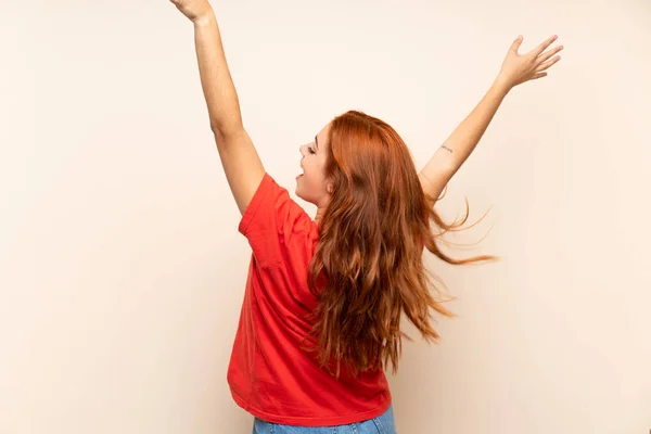 Teenager redhead girl dancing over isolated background — Stock Photo, Image