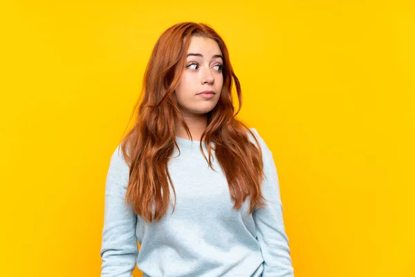 Teenager Redhead Girl Isolated Yellow Background Making Doubts Gesture Looking — 스톡 사진