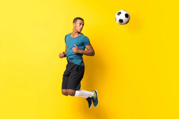 Afro American football player man over isolated yellow backgroun — Stock Photo, Image