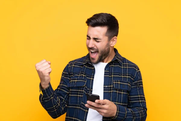 Young Handsome Man Beard Isolated Yellow Background Phone Victory Position — Stock Photo, Image