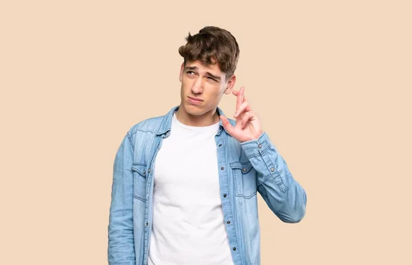 Handsome Young Man Fingers Crossing Wishing Best Isolated Background — Stock Photo, Image