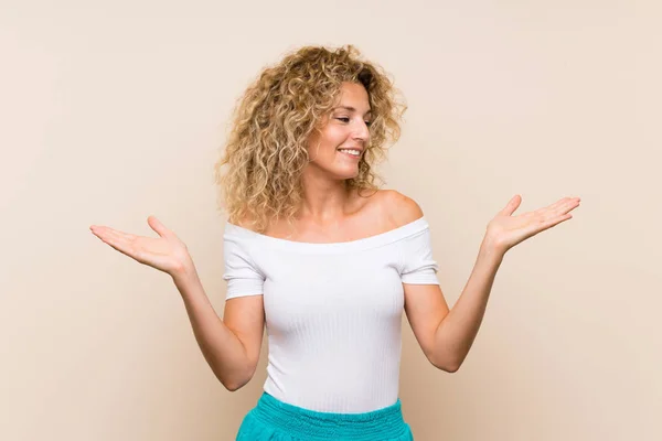 Young Blonde Woman Curly Hair Isolated Background Holding Copyspace Two — 스톡 사진