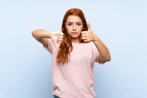 Teenager Redhead Girl Isolated Blue Background Making Good Bad Sign — 스톡 사진