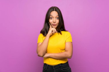 Young brunette girl over isolated background Looking front