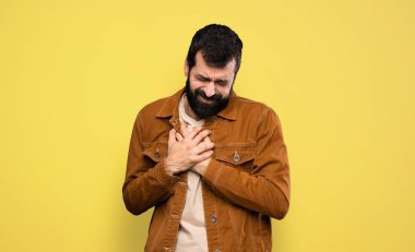 Handsome man with beard having a pain in the heart