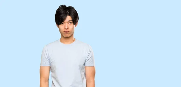 Asian Man Blue Shirt Sad Depressed Expression Isolated Blue Background — 스톡 사진