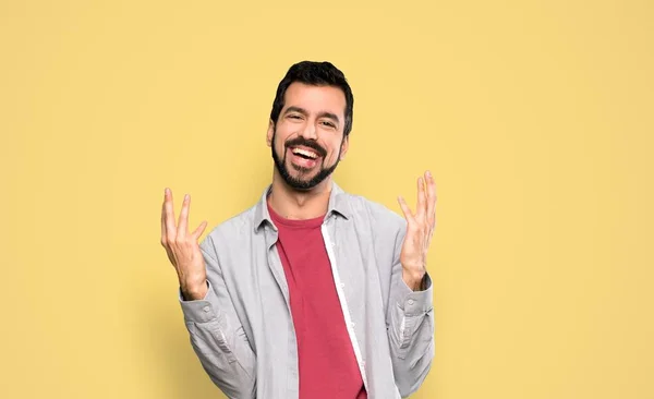 Handsome Man Beard Smiling Lot Isolated Yellow Background — 스톡 사진