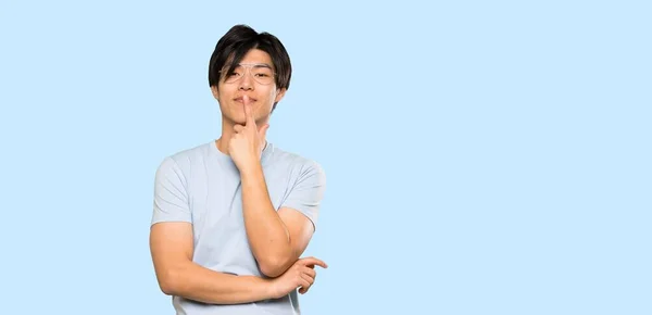 Asian Man Blue Shirt Glasses Smiling Isolated Blue Background — 스톡 사진