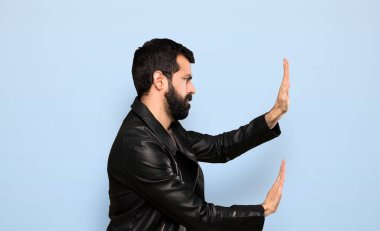 Handsome man with beard over isolated blue background