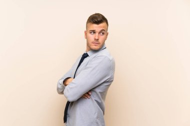 Izole arka plan üzerinde genç sarışın işadamı gülüyor