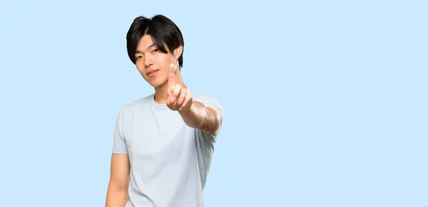 Asian Man Blue Shirt Showing Lifting Finger Isolated Blue Background — 스톡 사진