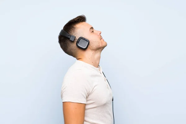 Young Handsome Blonde Man Isolated Blue Background Listening Music Headphones — Stock Photo, Image