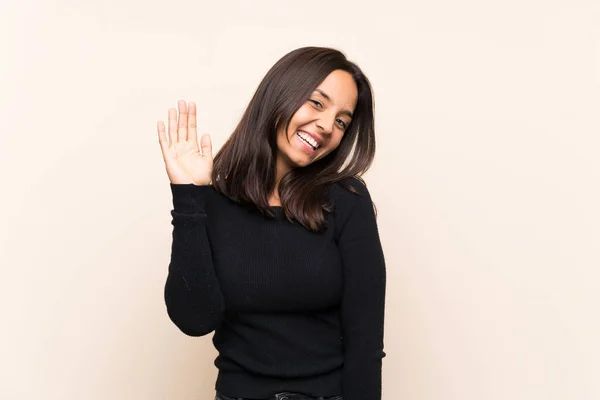 Young Brunette Woman White Sweater Isolated Background Saluting Hand Happy — 图库照片